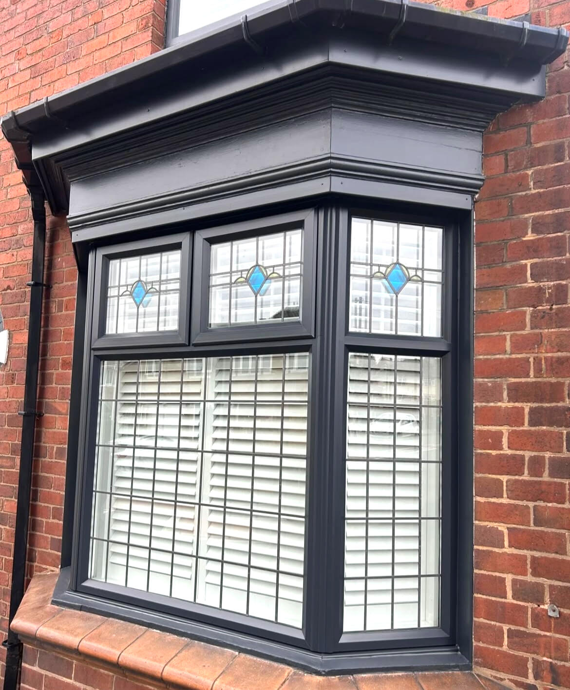 Anthracite grey UPVC bay window professionally sprayed by Wilkinson Specialist Sprays with a long-lasting exterior finish.
