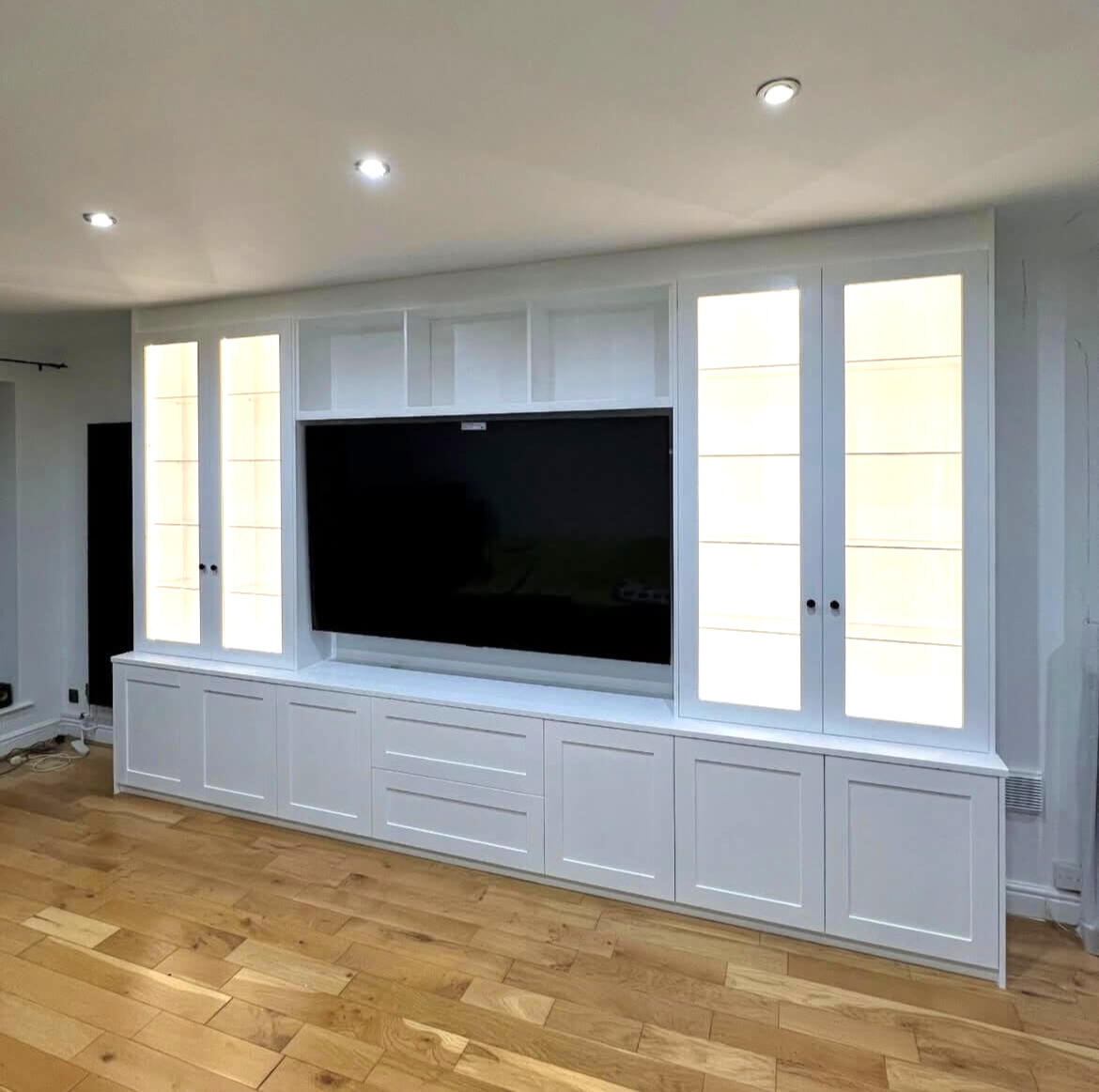 White sprayed fitted media wall after specialist furniture spraying in Tettenhall with a smooth factory finish.