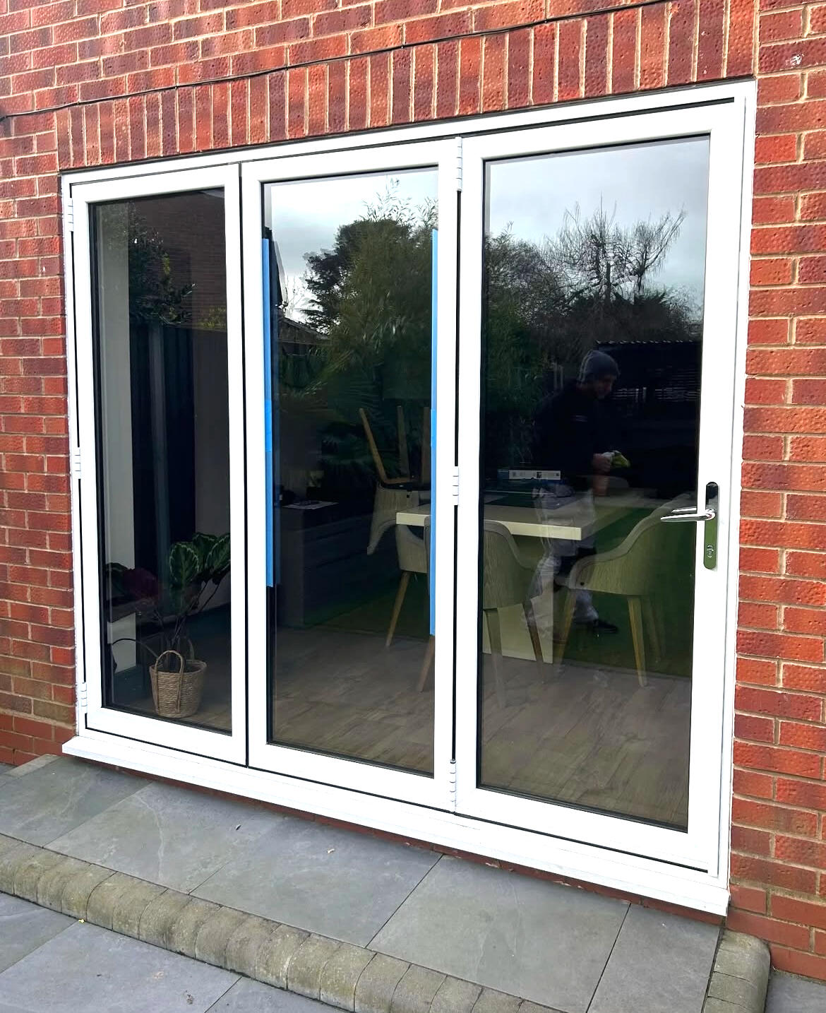 Before exterior patio door spraying showing white uPVC French doors.